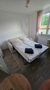 a bed in a room with two bags on it at Nicos Ferienwohnung in Grevesmühlen - ABC628 in Grevesmühlen
