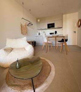 a living room with a couch and a table at Villa Loka-Ecrin contemporain Adult only in Sauzet