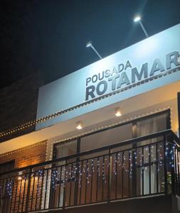 a building with a sign that reads pucada romanemen at Pousada Rotamar in Paraipaba