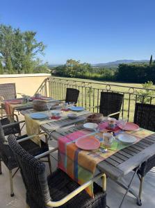 a table with plates and glasses on a patio at Au Clair Ventoux in Saint-Didier +53 photos