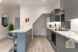 a kitchen with a counter top and a sink at Fairhurst House in Leigh