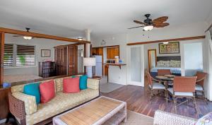 a living room with a couch and a dining room at Hanalei Colony Resort H4 in Hanalei