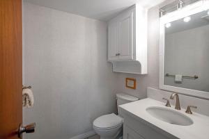 a bathroom with a toilet and a sink and a mirror at Hanalei Colony Resort H4 in Hanalei +29 photos