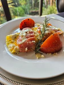 a white plate with food on a table at PhysEQFiT Guesthouse in Centurion +13 photos