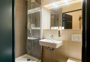a bathroom with a sink and a shower at B&B HOTEL Saint-Witz Roissy in Saint-Witz