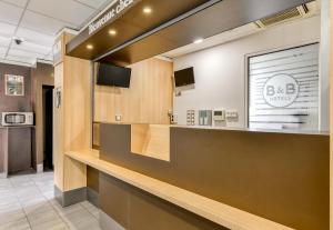a lobby of a dental office with a reception counter at B&B HOTEL Montpellier Centre Le Millénaire 3 étoiles in Montpellier