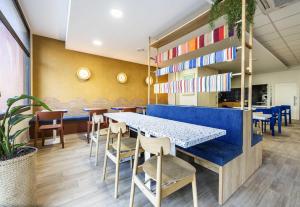 a dining room with a blue table and chairs at B&B HOTEL Perpignan Centre in Perpignan