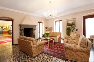 a living room with chairs and a fireplace at Garda Family House in Brenzone sul Garda