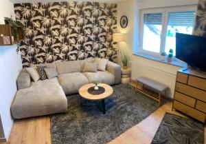 a living room with a couch and a table at Lucy’s apartment in Osijek
