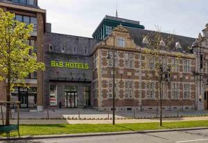 a large brick building with a lot of windows at B&B HOTEL Hasselt in Hasselt