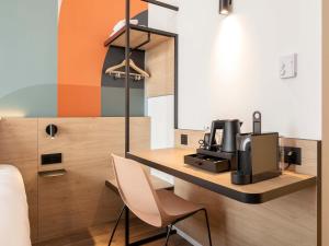 a room with a desk with a coffee machine on it at B&B HOTEL Namur in Namur