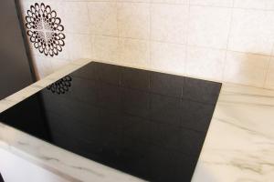 a bath tub with a black tile floor at Diamante - relax nature , WiFi in Arcumeggia +16 photos