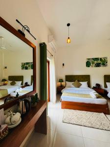 a bedroom with a large mirror and a bed at Blue Bird Hotels in Negombo