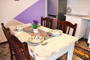 a table with plates and bowls on it in a kitchen at Diamante - relax nature , WiFi in Arcumeggia