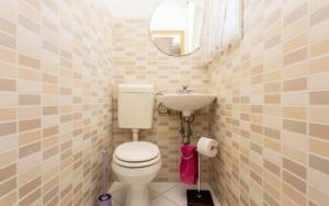 a small bathroom with a toilet and a sink at Apartman Maledi in Baška