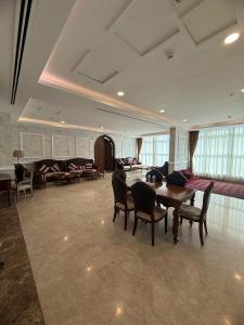 a large room with a table and chairs and a couch at Karam Al Balad Hotel in Jeddah +45 photos