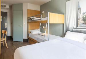 a bedroom with a bed and a bunk bed at B&B HOTEL Rennes Est Cesson Sévigné 3 étoiles in Cesson-Sévigné