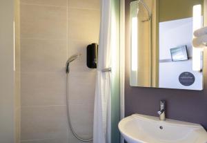 a bathroom with a shower and a sink at B&B HOTEL Lorient Caudan in Caudan