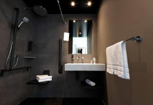 a bathroom with a sink and a mirror at B&B HOTEL St Gallen in St. Gallen +42 photos