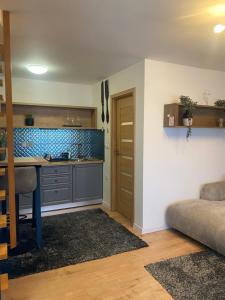 a kitchen with a table and a counter in a room at Lucy’s apartment in Osijek