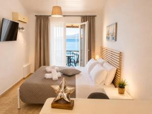 a bedroom with a bed with a teddy bear on it at Novus seaview in Benitses