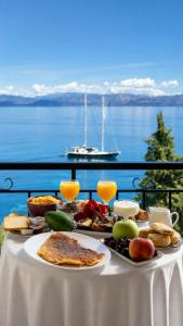 a table with food on it with a view of the water at Novus seaview in Benitses