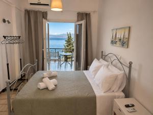 a bedroom with a bed with a teddy bear on it at Novus seaview in Benitses