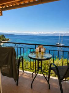 a table on a balcony with a view of the ocean at Novus seaview in Benitses