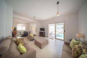 a living room with a couch and a table at La Villa - Protaras in Paralimni
