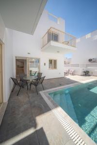 a villa with a swimming pool and a house at La Villa - Protaras in Paralimni +38 photos