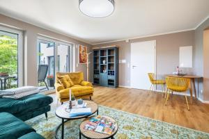 a living room with a couch and a table at Haus am See in Malchow