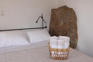 a basket of toilet paper sitting on a bed at Litharaki Guest House in Ano Syros