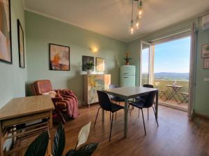 a living room with a table and chairs at My Tuscany Green Apartment in San Quirico dʼOrcia