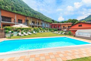 a swimming pool in front of a resort at Residence Borgo Castello B1 Apartment in Argegno