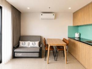 a small kitchen with a table and a chair at Ngoc Thuong Hotel & Apartment- Han River View in Danang