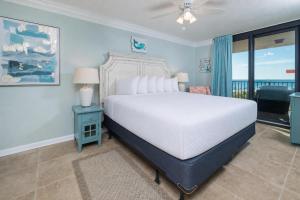 a bedroom with a white bed and a window at Phoenix East 203 condo in Orange Beach +52 photos