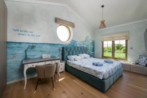 a bedroom with a bed and a desk and a window at Villa Da Ella by IstriaLux in Krnica +40 photos