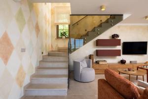 a staircase in a house with a living room at Villa Da Ella by IstriaLux in Krnica