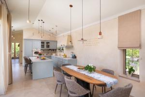 a kitchen and dining room with a table and chairs at Villa Da Ella by IstriaLux in Krnica