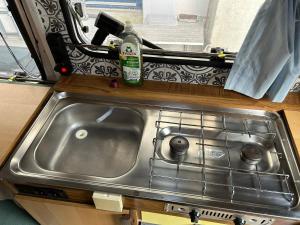 a sink in a rv kitchen with a window at Charmantes Oldtimer Wohnmobil in Aachen +19 photos