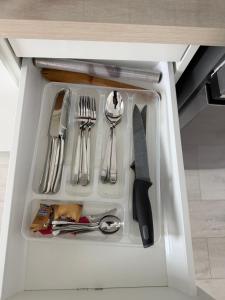 a drawer filled with utensils in a cabinet at Apartament in Ploiesti 8 in Ploieşti