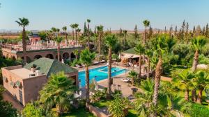 an aerial view of a resort with a pool and palm trees at Just V hotel & Spa in Marrakesh