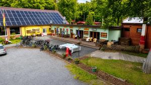 an aerial view of a house with a solar roof at Natura Ferienpark - Bungalows am Grimnitzsee Schorfheide in Althüttendorf