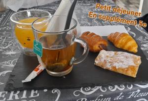 a tray with a cup of tea and some pastries at Chez JP & NATH in Alcossebre +1 photo