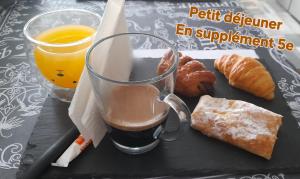 a tray with a cup of coffee and some pastries at Chez JP & NATH in Alcossebre