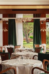 a dining room with tables and chairs and a window at Locanda Cipriani in Torcello
