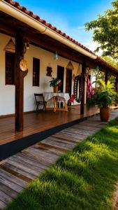 a wooden deck of a house with a table at Chalé Canto do Rio in Santo Amaro