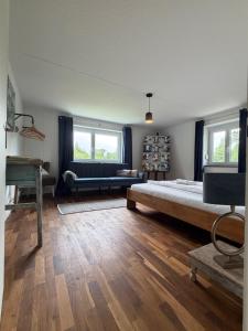 a bedroom with a large bed and a couch at Kirchstett in Sankt Wolfgang