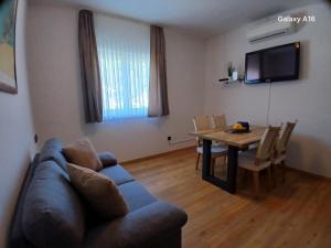 a living room with a couch and a dining room table at Apartments Nadine Mljet Komfort mit Meerblick in Okuklje
