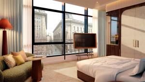 a bedroom with a bed and a tv and a window at Petra Hotel Belgrade in Belgrade